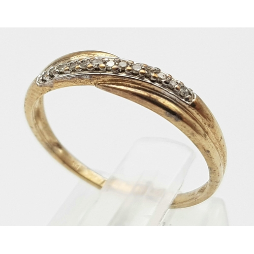 1493 - A 9K Yellow Gold Diamond Crossover Ring. Size M. 1.27g weight.