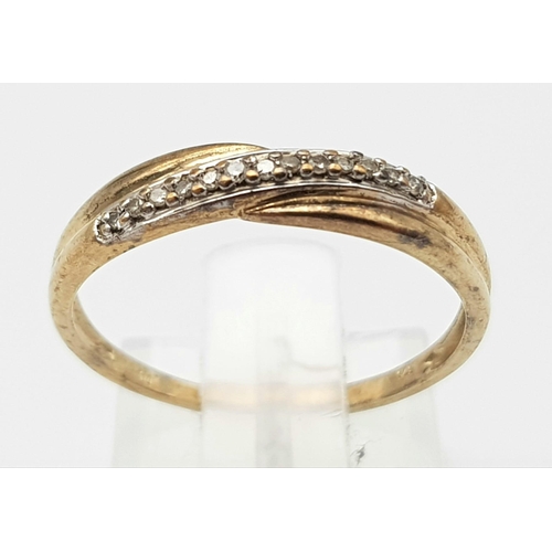 1493 - A 9K Yellow Gold Diamond Crossover Ring. Size M. 1.27g weight.