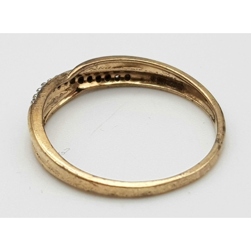 1493 - A 9K Yellow Gold Diamond Crossover Ring. Size M. 1.27g weight.