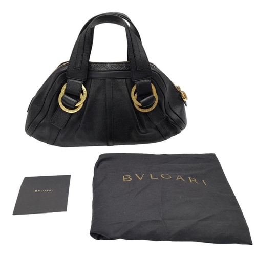 363 - A Bvlgari Black Polly Handbag. Black leather exterior with gold-toned hardware with two leather stra... 