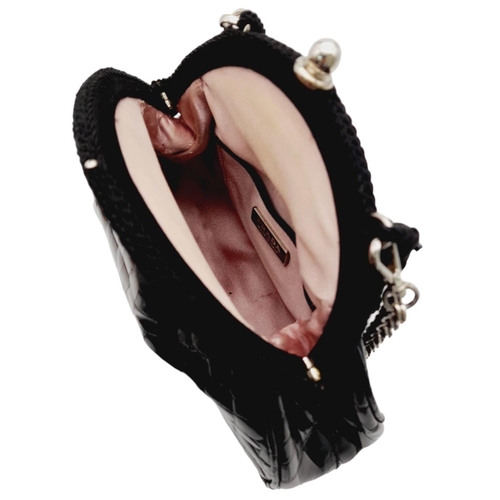 192 - A Prada Black Coccodrillo Evening Bag. Crocodile leather exterior with silver-toned hardware, textil... 