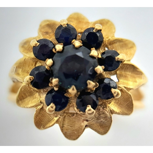 179 - A 18K YELLOW GOLD SAPPHIRE SET CLUSTER RING. TOTAL WEIGHT 6.2G. SIZE N. REF BL 6003