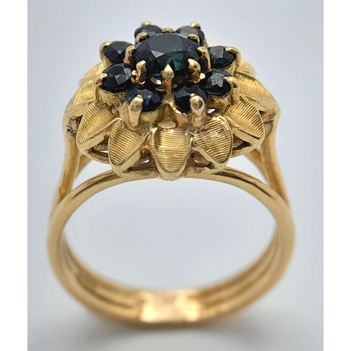 179 - A 18K YELLOW GOLD SAPPHIRE SET CLUSTER RING. TOTAL WEIGHT 6.2G. SIZE N. REF BL 6003