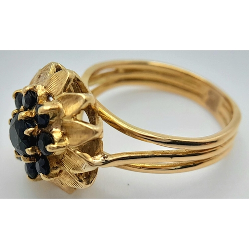 179 - A 18K YELLOW GOLD SAPPHIRE SET CLUSTER RING. TOTAL WEIGHT 6.2G. SIZE N. REF BL 6003