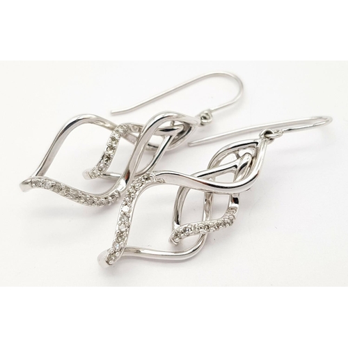 446 - A PAIR OF 9K WHITE GOLD DIAMOND SET SWIRL DESIGN DROP EARRINGS 4.4G TOTAL WEIGHT, 2.5CM LENGTH.

ref... 