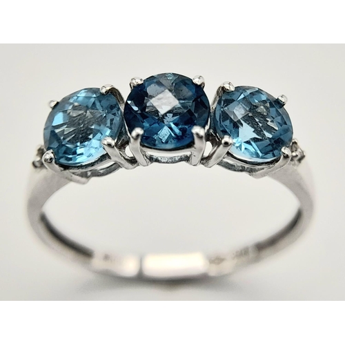 458 - A Stunning 9 Carat White Gold, Blue Topaz and Diamond Ring Size O. Set with three 5mm Round cut Blue... 