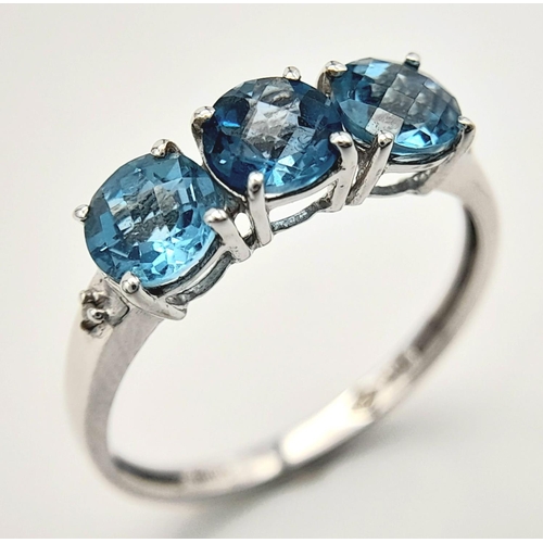 458 - A Stunning 9 Carat White Gold, Blue Topaz and Diamond Ring Size O. Set with three 5mm Round cut Blue... 