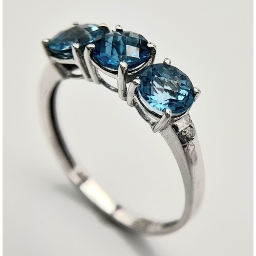 458 - A Stunning 9 Carat White Gold, Blue Topaz and Diamond Ring Size O. Set with three 5mm Round cut Blue... 