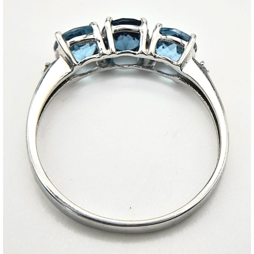 458 - A Stunning 9 Carat White Gold, Blue Topaz and Diamond Ring Size O. Set with three 5mm Round cut Blue... 