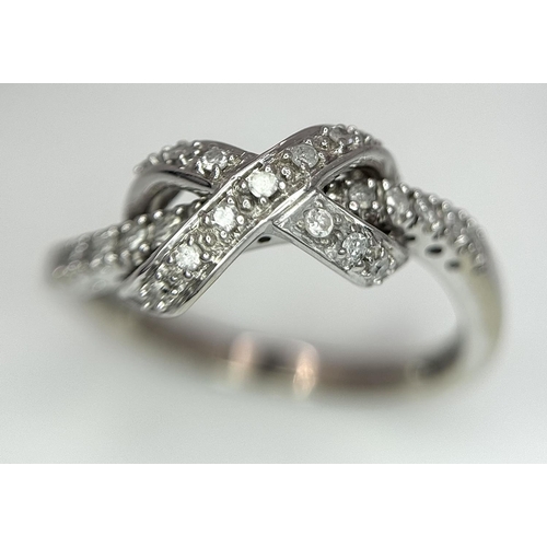 607 - 9K WHITE GOLD DIAMOND SET BOW RING. 2.85G IN WEIGHT. SIZE P. 0.12CT.
Ref: 4957.