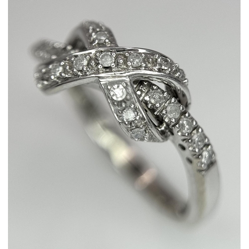 607 - 9K WHITE GOLD DIAMOND SET BOW RING. 2.85G IN WEIGHT. SIZE P. 0.12CT.
Ref: 4957.