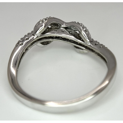 607 - 9K WHITE GOLD DIAMOND SET BOW RING. 2.85G IN WEIGHT. SIZE P. 0.12CT.
Ref: 4957.