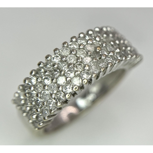 516 - A 9K WHITE GOLD 0.75CT DIAMOND 4 ROW RING. TOTAL WEIGHT 3.1G. SIZE J. REF A/S 1123