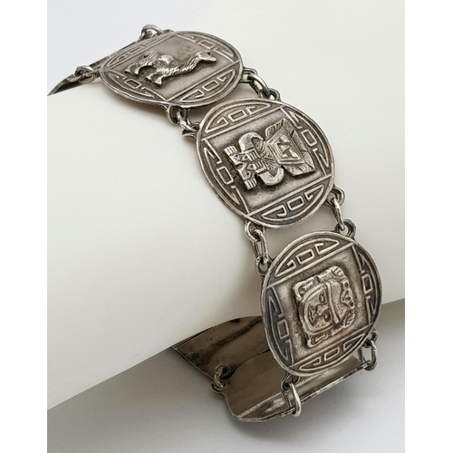 628 - SILVER AZTEC DESIGN BRACELET. 26.12G IN WEIGHT.
Ref: 8065.