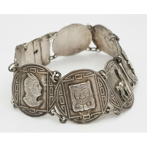 628 - SILVER AZTEC DESIGN BRACELET. 26.12G IN WEIGHT.
Ref: 8065.