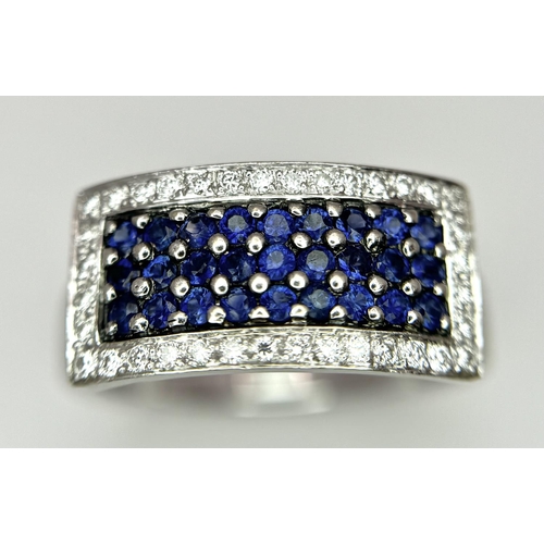 53 - An 18K White Gold Sapphire Ring with Diamond Surround. Size O. 7.4g total weight.