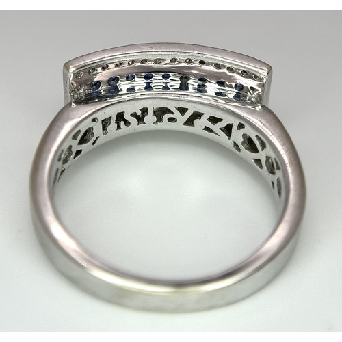 53 - An 18K White Gold Sapphire Ring with Diamond Surround. Size O. 7.4g total weight.