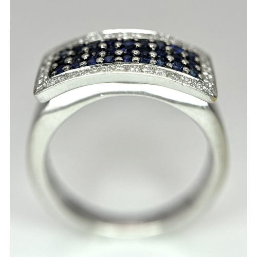 53 - An 18K White Gold Sapphire Ring with Diamond Surround. Size O. 7.4g total weight.