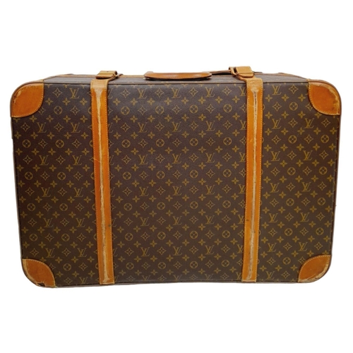 213 - A Louis Vuitton Vintage Large Suitcase. Monogrammed canvas exterior with leather trim, gold-toned ha... 