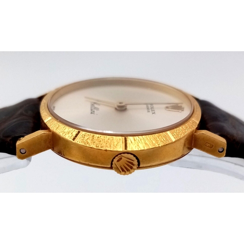 148 - A LADIES 18K GOLD ROLEX CELLINI WITH MOTHER OF PEARL DIAL AND ON A BROWN CROCODILE STRAP , ONE OF TH... 