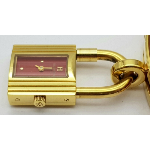 276 - A HERMES OF PARIS NOVELTY PADLOCK ON A BRACELET LADIES WATCH , GOLD PLATED AND ON A RED HERMES LEATH... 