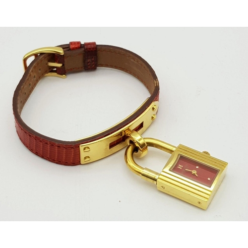 276 - A HERMES OF PARIS NOVELTY PADLOCK ON A BRACELET LADIES WATCH , GOLD PLATED AND ON A RED HERMES LEATH... 