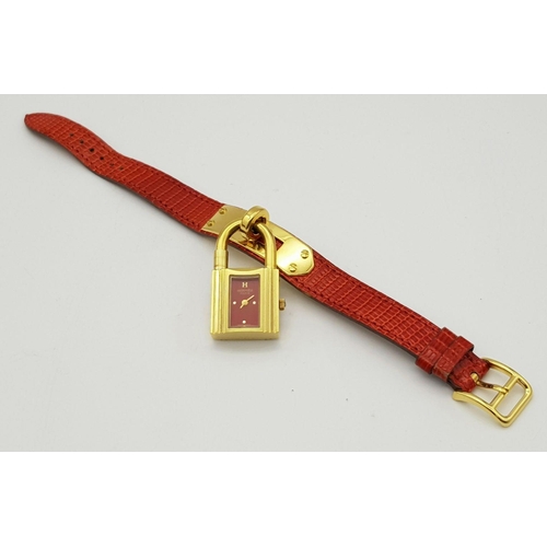 276 - A HERMES OF PARIS NOVELTY PADLOCK ON A BRACELET LADIES WATCH , GOLD PLATED AND ON A RED HERMES LEATH... 