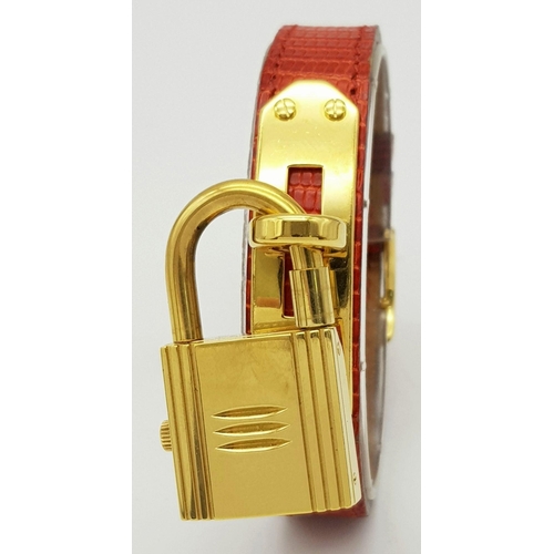 276 - A HERMES OF PARIS NOVELTY PADLOCK ON A BRACELET LADIES WATCH , GOLD PLATED AND ON A RED HERMES LEATH... 