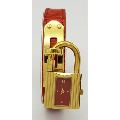 276 - A HERMES OF PARIS NOVELTY PADLOCK ON A BRACELET LADIES WATCH , GOLD PLATED AND ON A RED HERMES LEATH... 