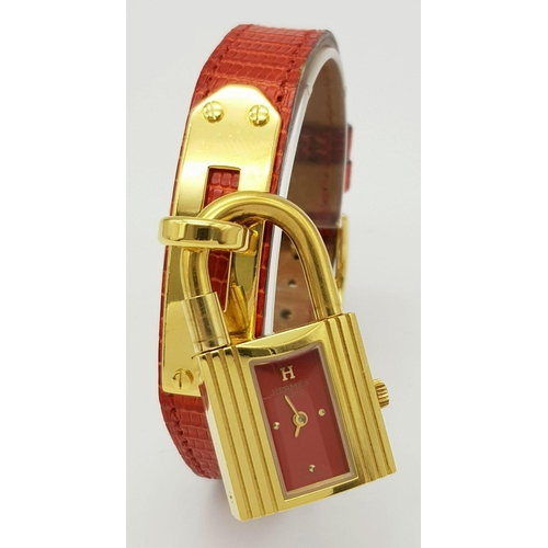 276 - A HERMES OF PARIS NOVELTY PADLOCK ON A BRACELET LADIES WATCH , GOLD PLATED AND ON A RED HERMES LEATH... 