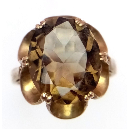 37 - A 9K GOLD DRESS RING WITH LARGE SMOKEY QUARTZ CENTRE STONE  .      3.2gms    size J