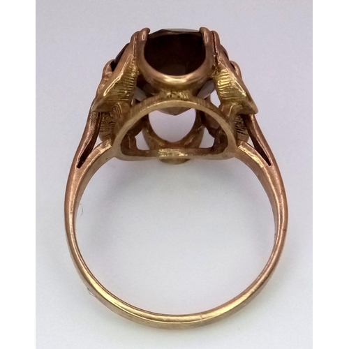 37 - A 9K GOLD DRESS RING WITH LARGE SMOKEY QUARTZ CENTRE STONE  .      3.2gms    size J