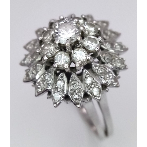 4 - A FABULOUS 3 TIERED DIAMOND CLUSTER RING SET IN 18K WHITE GOLD .    6.3gms    size O