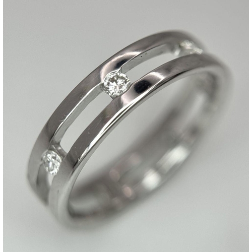 424 - A 18K white gold spaced out diamond set band ring. size O, (dia: 0.35ct). Total weight 4g. Ref 2405H