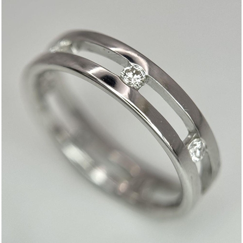 424 - A 18K white gold spaced out diamond set band ring. size O, (dia: 0.35ct). Total weight 4g. Ref 2405H