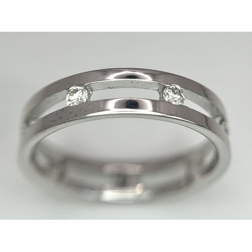 424 - A 18K white gold spaced out diamond set band ring. size O, (dia: 0.35ct). Total weight 4g. Ref 2405H