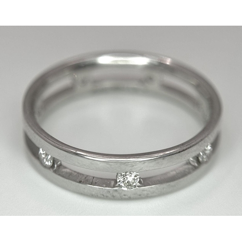 424 - A 18K white gold spaced out diamond set band ring. size O, (dia: 0.35ct). Total weight 4g. Ref 2405H