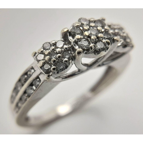 505 - A 9K white gold diamond cluster ring with 2 row diamond set shoulders. Size L1/2. (dia: 0.40ct). Tot... 