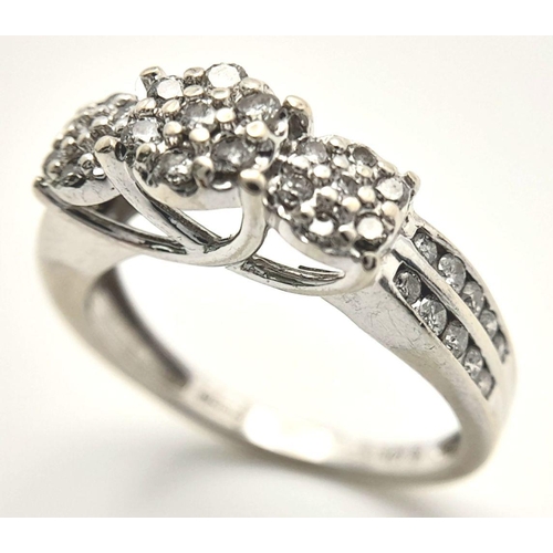 505 - A 9K white gold diamond cluster ring with 2 row diamond set shoulders. Size L1/2. (dia: 0.40ct). Tot... 