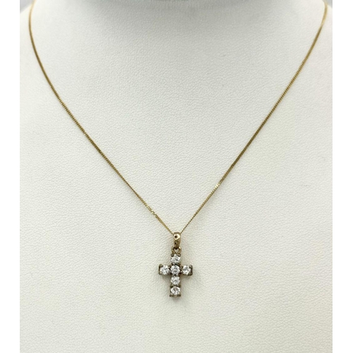 87 - A VERY PRETTY STONE SET CROSS PENDANT IN 9K GOLD AND ON AN 40cms DISAPPEARING NECK CHAIN .  1.8gms