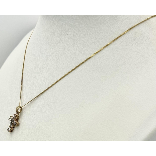 87 - A VERY PRETTY STONE SET CROSS PENDANT IN 9K GOLD AND ON AN 40cms DISAPPEARING NECK CHAIN .  1.8gms