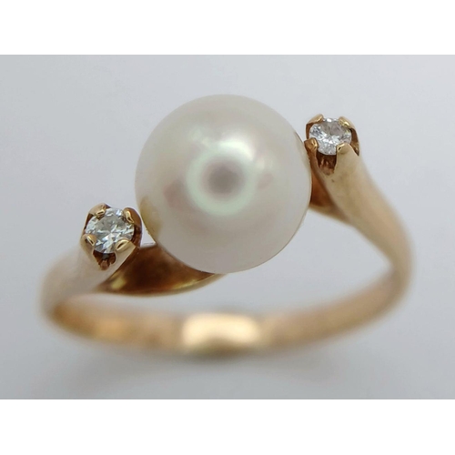 88 - An 18K Yellow Gold Pearl and Diamond Twist Ring. Size M/N. 3.3g total weight.