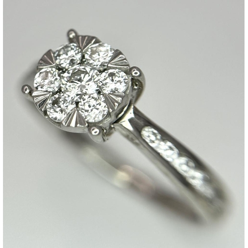 95 - A 9K White Gold Diamond Cluster Ring. Size S. 3.5g total weight.