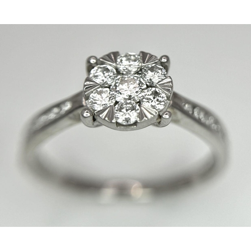 95 - A 9K White Gold Diamond Cluster Ring. Size S. 3.5g total weight.