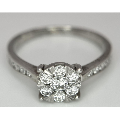 95 - A 9K White Gold Diamond Cluster Ring. Size S. 3.5g total weight.