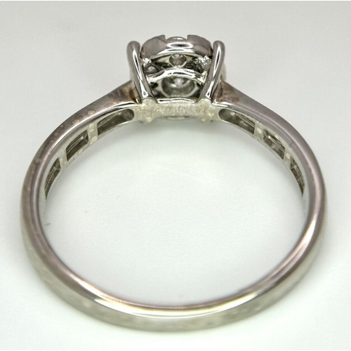 95 - A 9K White Gold Diamond Cluster Ring. Size S. 3.5g total weight.