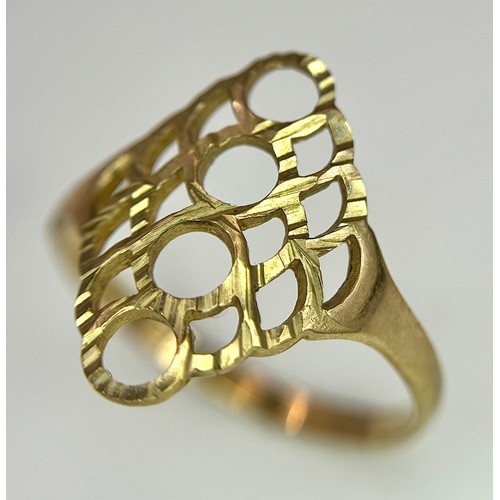 241 - A 9K Yellow Gold Ring with Pierced Circle Decoration. Size N. 1.4g.