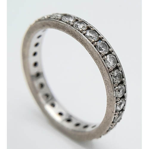 225 - A STONE SET FULL SILVER ETERNITY RING  .   4.8gms   size T