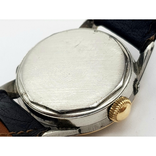 303 - A VINTAGE MOVADO GENTS WATCH IN GOLD AND STAINLESS STEEL WITH GREAT PATINA TO THE DIAL ,  MANUAL MOV... 