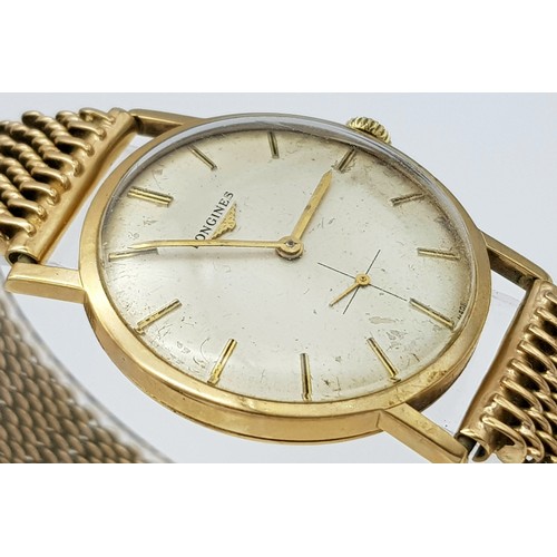 156 - A Vintage 9K Gold Longine Mechanical Watch. 9K Gold bracelet and case - 33mm. Patinaed cream dial wi... 